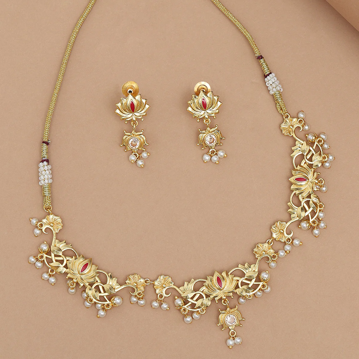 Apsara Faux Pearls Adorned Brass Lotus Motifs Gold Plated Jewellery Set