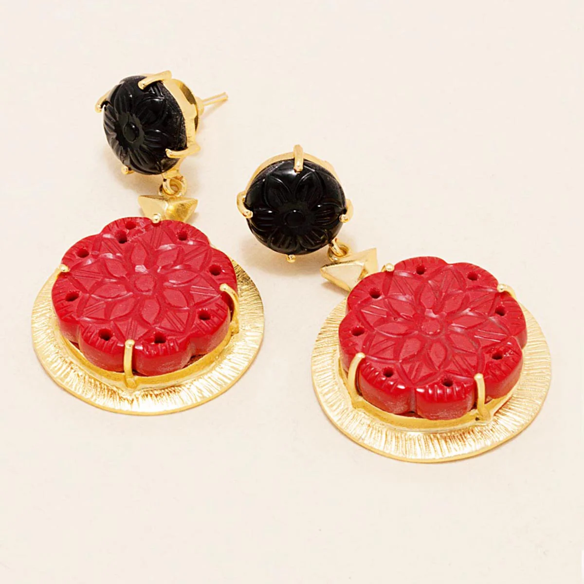 gold tone dangler earrings adorned with black-red floral design engraved stones